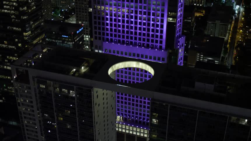 An aerial view of 500 Brickell and Brickell World Plaza two towering high rise buildings in Downtown Miami with a clear and stunning night skyline