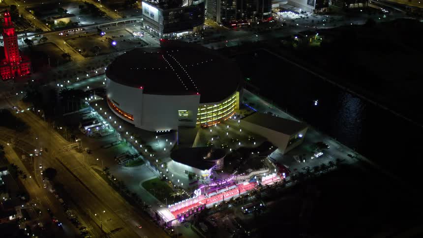 A captivating aerial view of American Airlines Arena lit up at night in the heart of Downtown Miami Florida