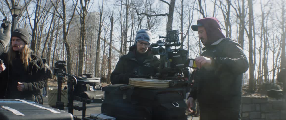 A cameraman and crew on an outdoor set
