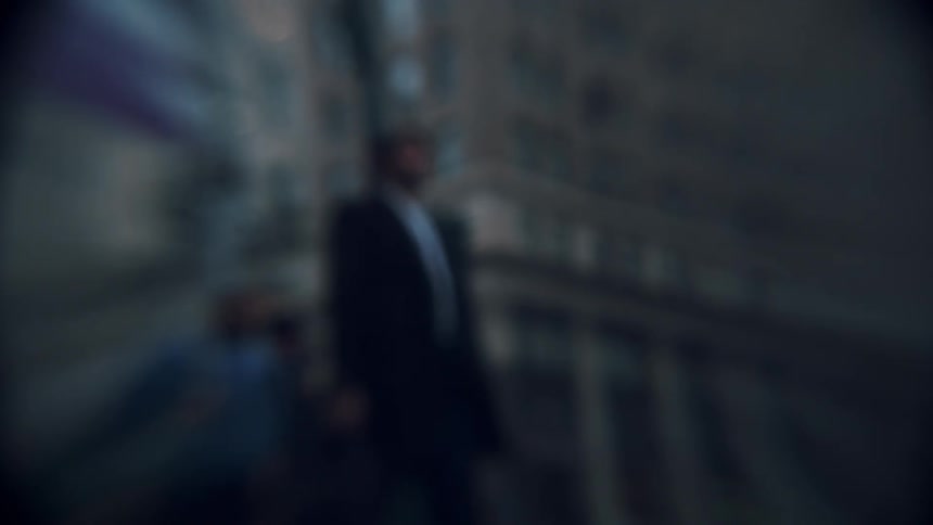 People walk down a crowded city sidewalk