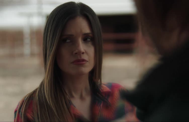 A woman is being talked at by someone looking apprehensive