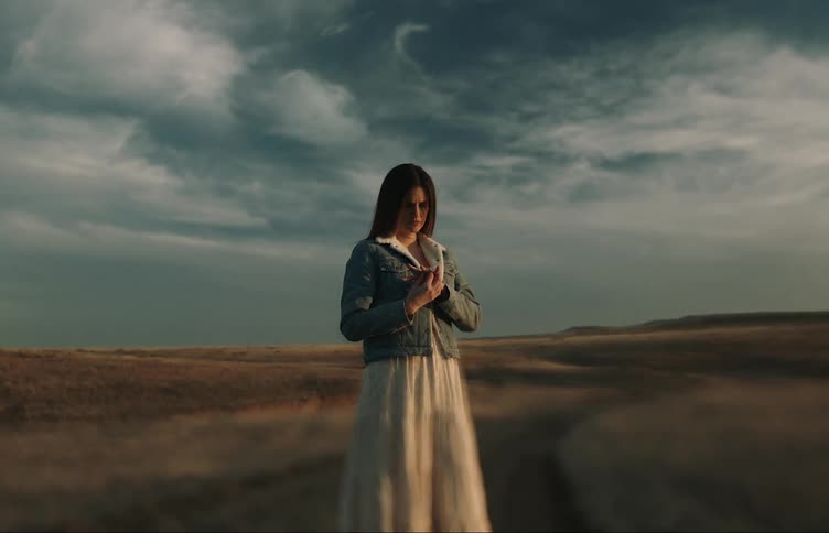A woman is standing on the field