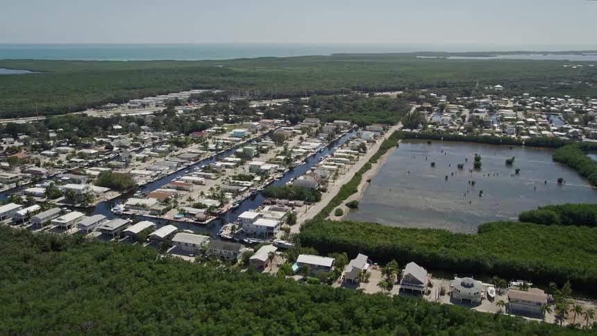 A stunning aerial view of the waterfront homes along the canals of Key Largo Florida on a sunny day