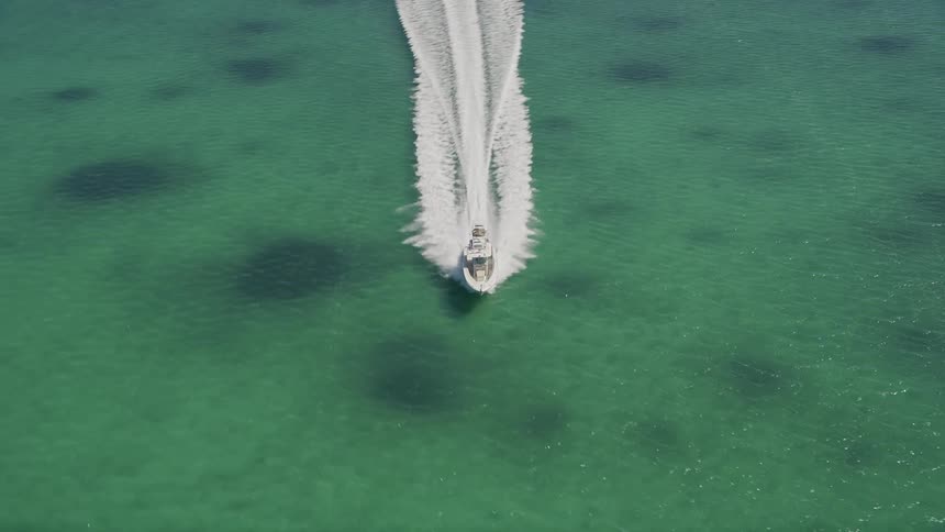 An aerial view of a fishing boat traveling at high speed through Floridas waters in Tavernier