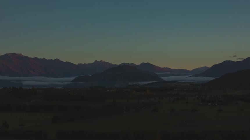 Town sitting on coast becomes visible as day dawns