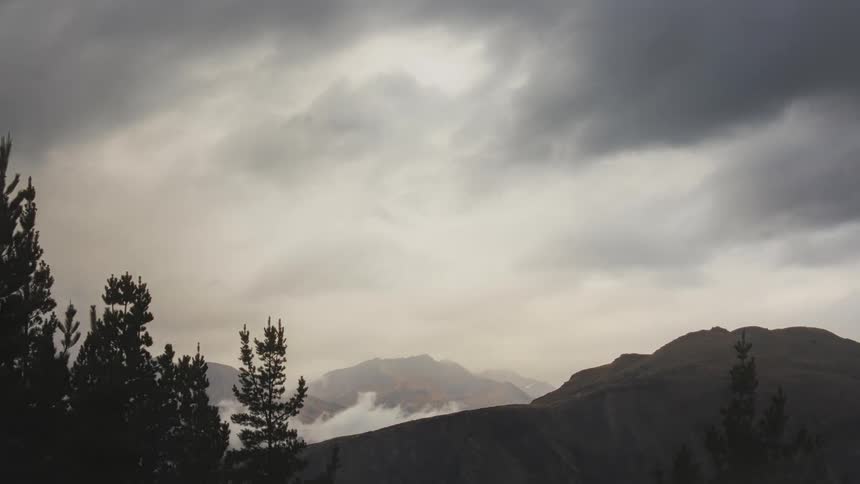 The clouds flow over the mountains