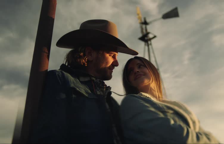 A man and woman stand outside