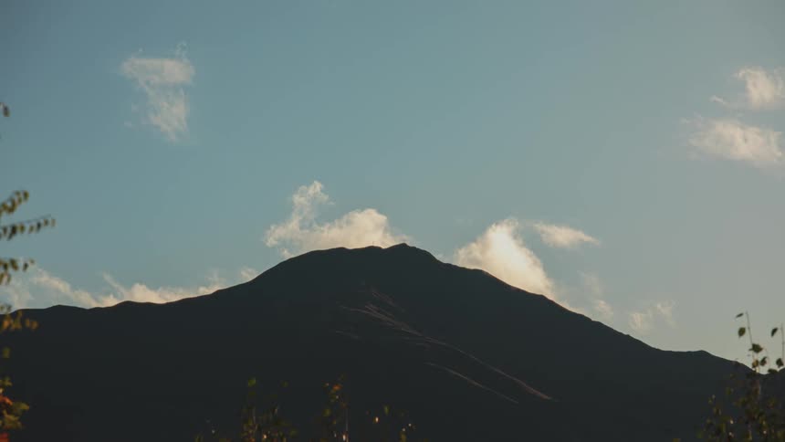 Clouds move over a mountain range