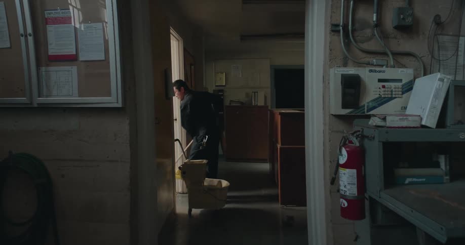 A person is cleaning a building at his job