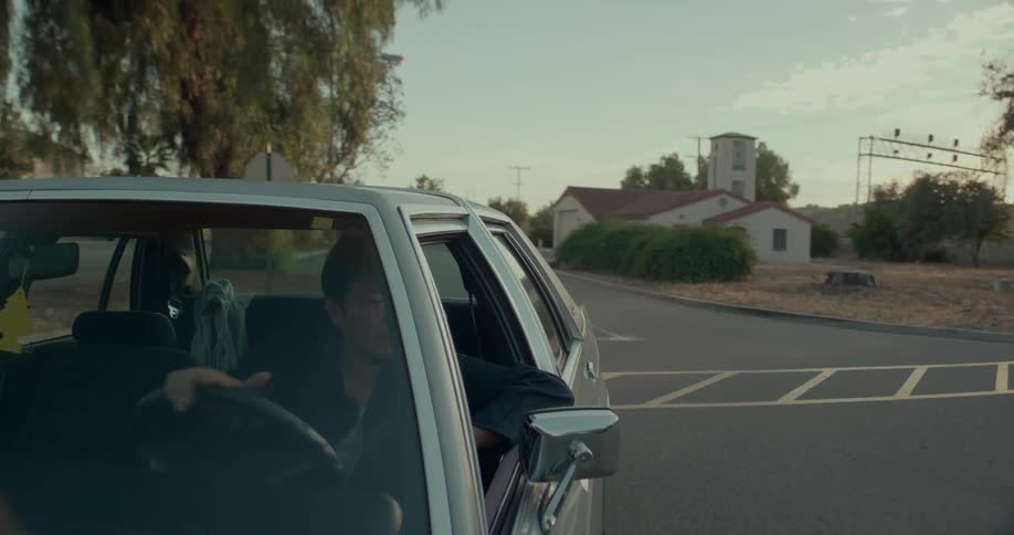 Asian man driving a car