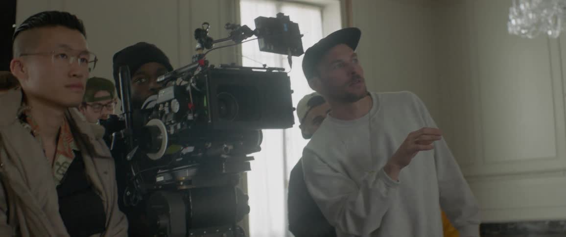 Camera crew films in a small room