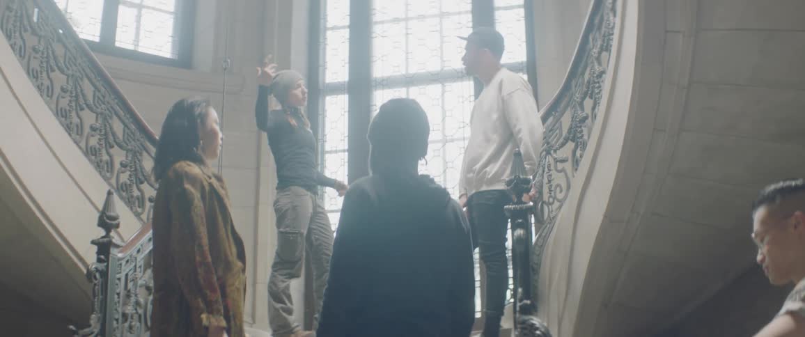 Group of people talk on a staircase on a sunny day