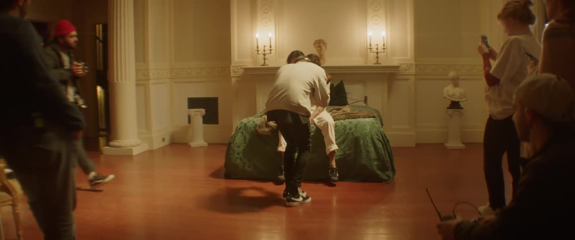 A man and woman are filmed on a bed