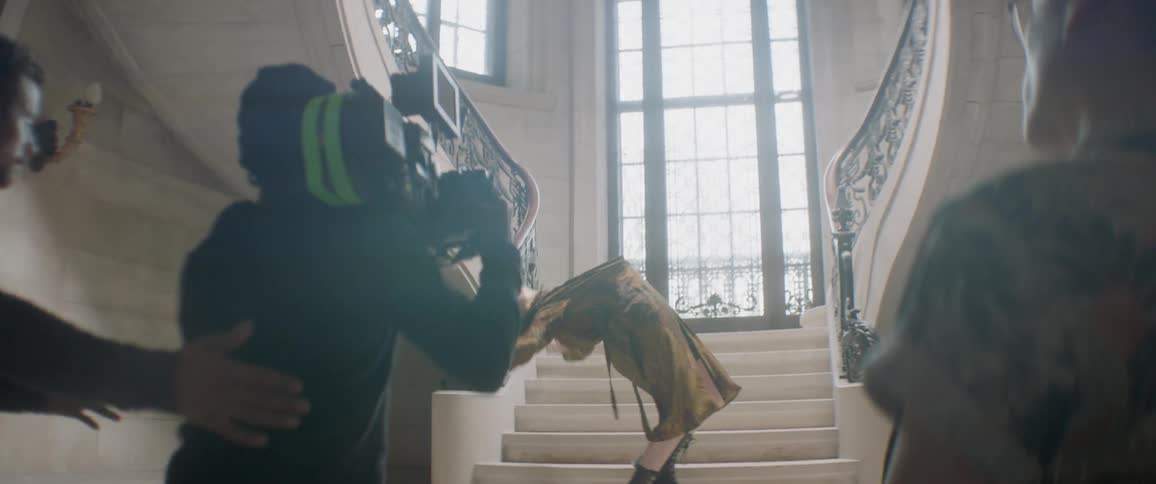 A man falls backwards on the steps as he is being filmed