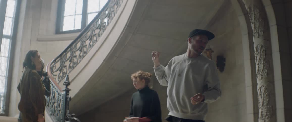 People look at an elaborate stairwell