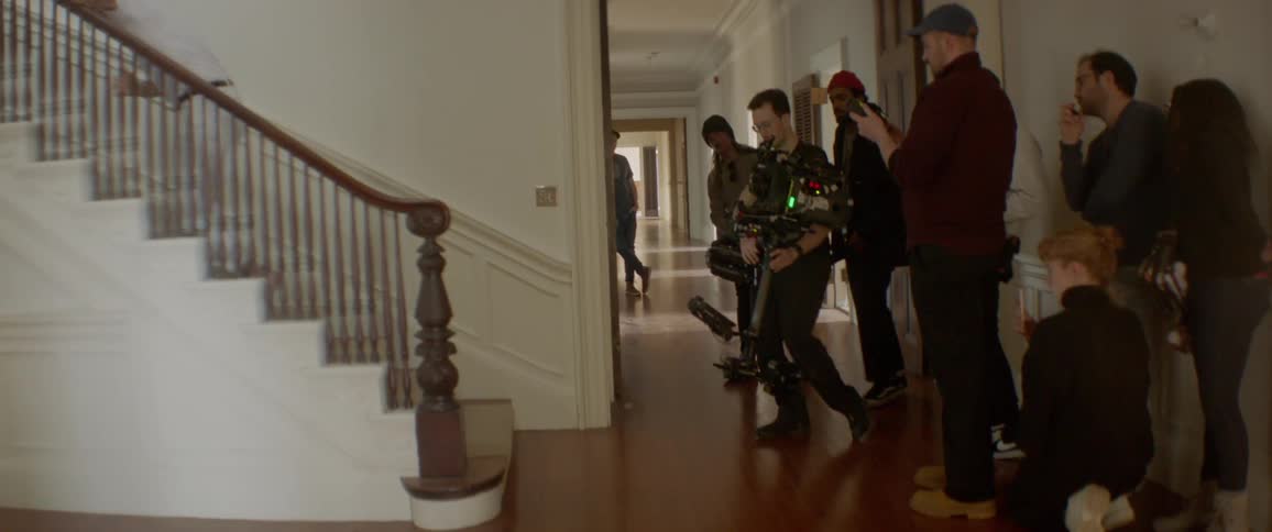 A film crew works inside a house