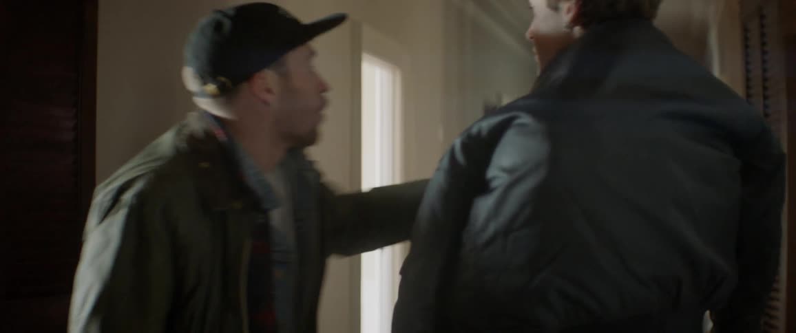 The people walk down the hall talking