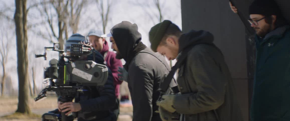 People are filming something on a cloudy day