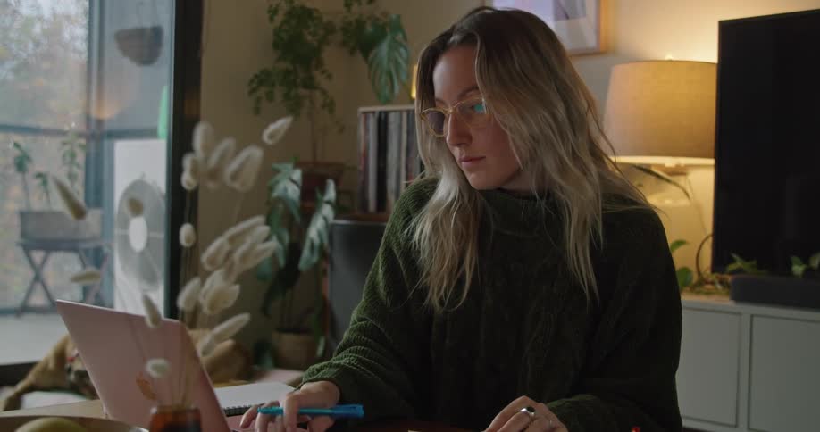 A woman works on her laptop
