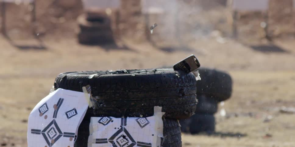 A phone sticking out of a tire is shot