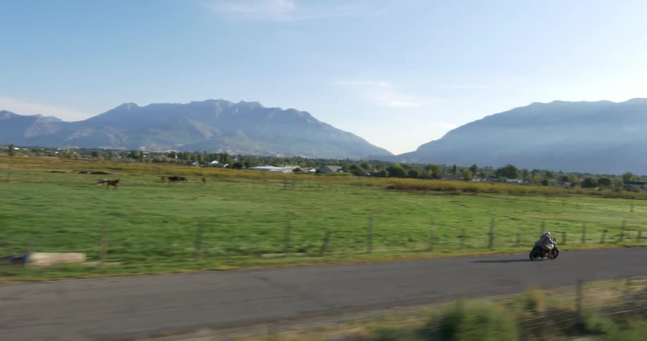 Man rides a motorcycle in a rural area