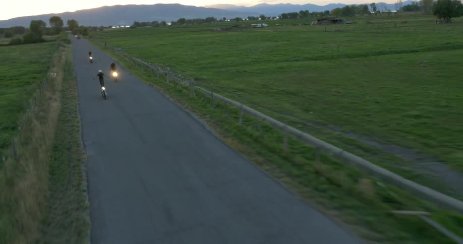People on motorcycles race and stand up