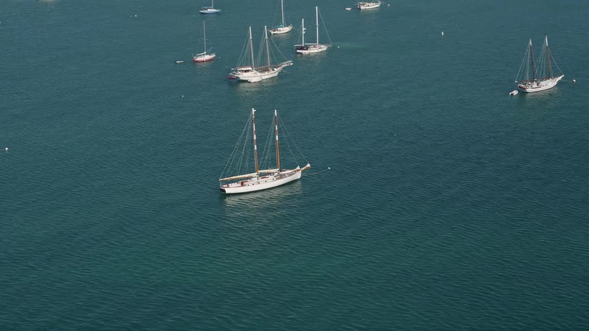 Aerial footage of sailboat moored off the shore of Key West Florida during summer