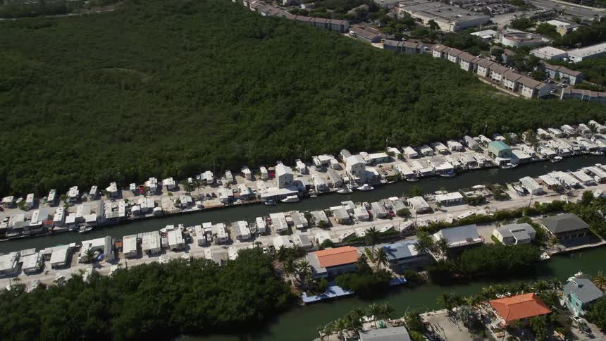 Aerial view of residential homes situated on a coastal canal in Marathon Florida during the summer