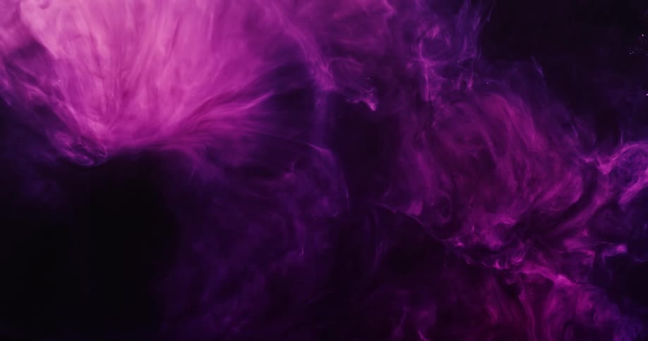 Pink and purple smoke fills a dark room