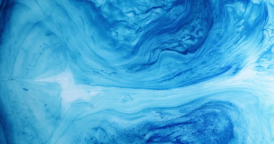 Close up view of blue liquids mixing together