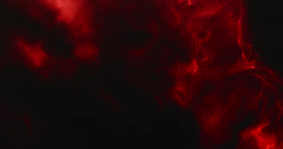 An abstract design of red and black smoke like swirls moving around slowly