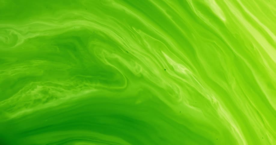 Various shades of green and cream swirl and flow in mixture