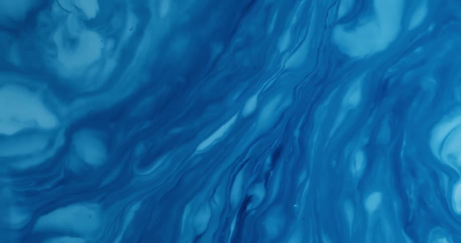 Swirled lines form in blue paint