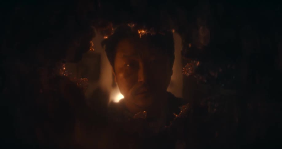 A man reaches into a closing hole