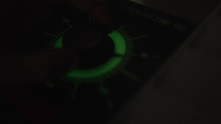 Person adjusts dial to change setting