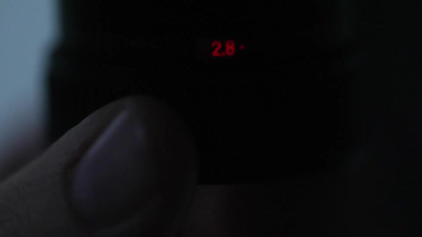 Close-up of enlarger or camera lens in low light, cinematic equipment detail