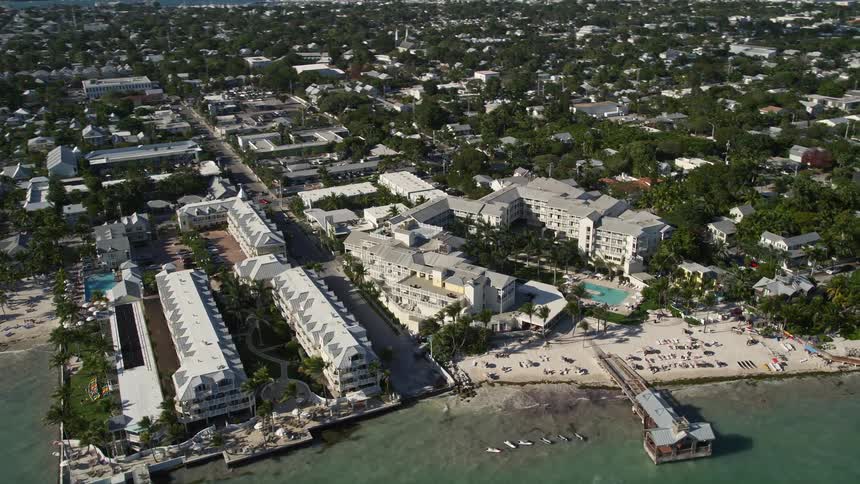 A breathtaking aerial view of The Reach A Waldorf Astoria Resort in Key West Florida with a beautiful pier and stunning coastline
