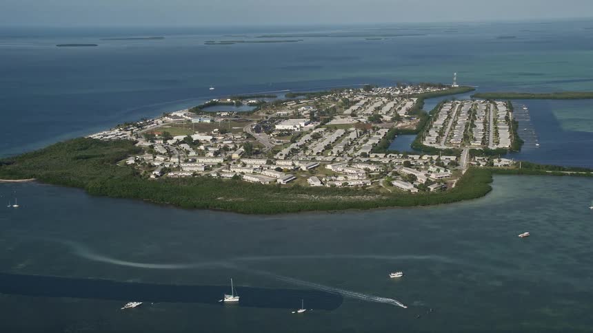 Aerial footage of Sigsbee Park Key West Florida showcasing the naval air station marina and surrounding coastline during a sunny day