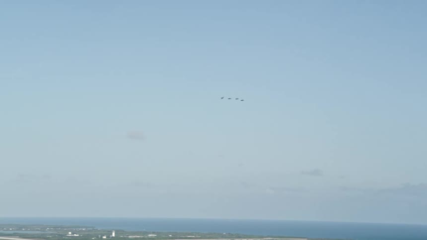Aerial footage of four F-18s flying over Naval Air Station Key West on a sunny day