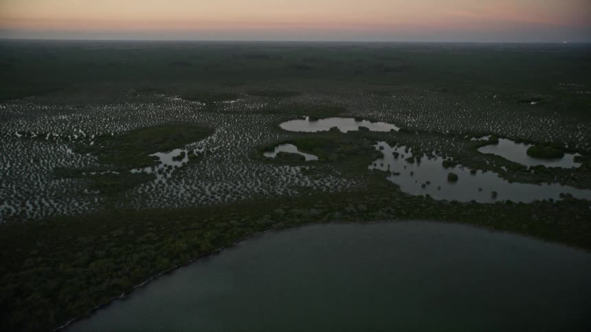 Aerial footage at twilight reveals the stunning wetlands and coastline of Southern Glades Florida