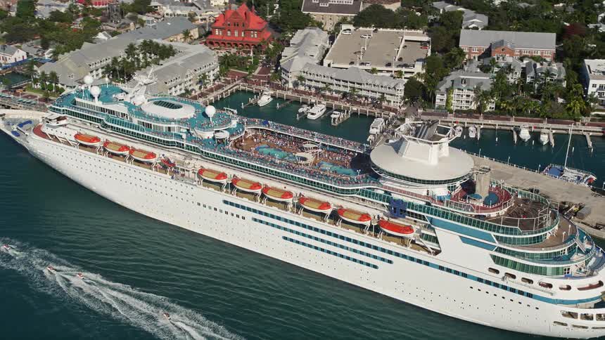 A Royal Caribbean cruise ship is seen docked in Key West FL during a sunny daytime aerial view showcasing maritime recreation and a leisure vacation destination