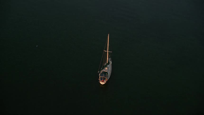 An aerial view of a sailboat approaching during sunset in Key Largo Florida