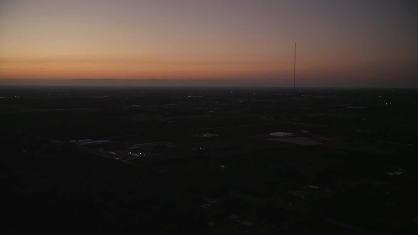 An aerial video flying over Homestead Florida at twilight with the coastline in the distance