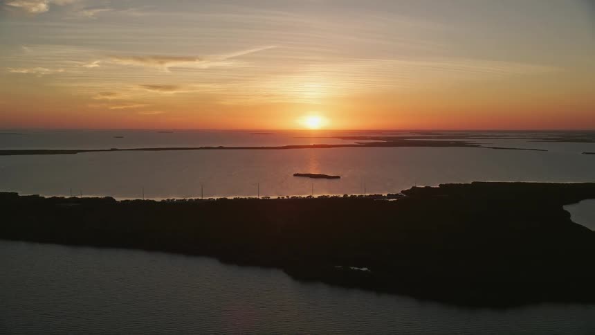 Flying over Key Largos bays mangroves and tree-covered islands during sunset