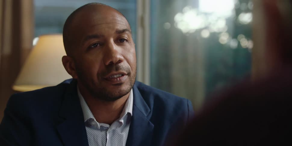 A man speaks with his hands while talking to a client