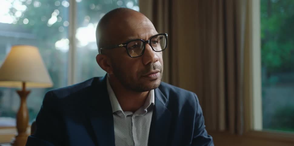 Insurance agent or consultant sitting across the table from someone at their home discussing options retirement planning estate planning etc shaking head stern daytime