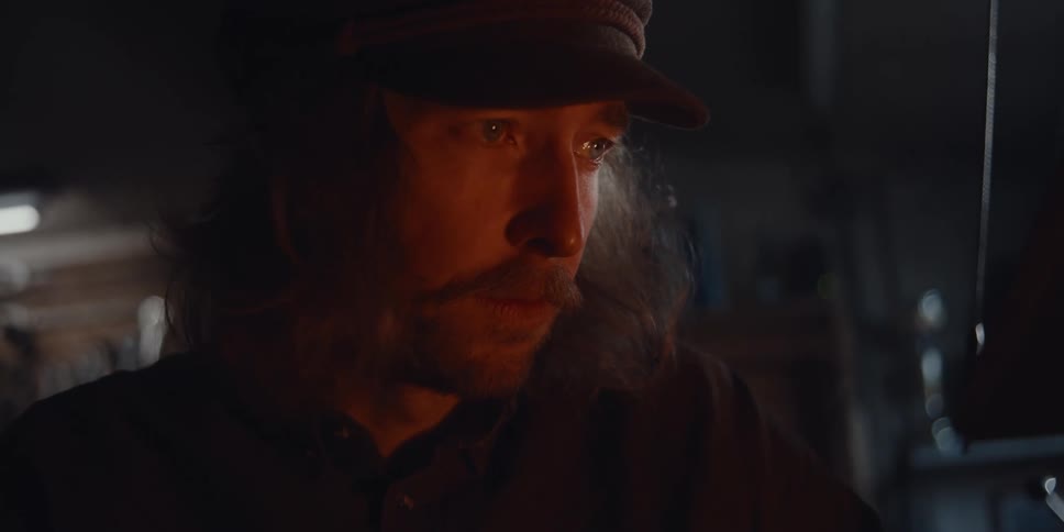 A man is watching the flame