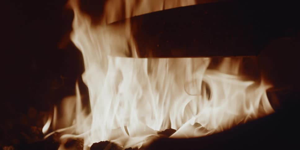 Nighttime fire putting a huge butcher knife blade into the fire