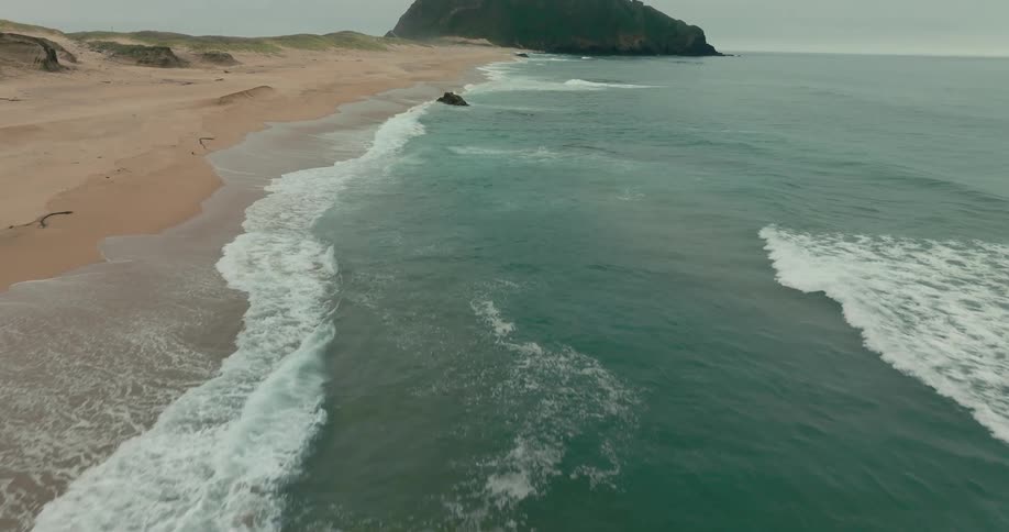 Flying over a stretch of rugged beach
