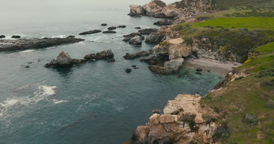 Drone aerial of rugged rocks and beach